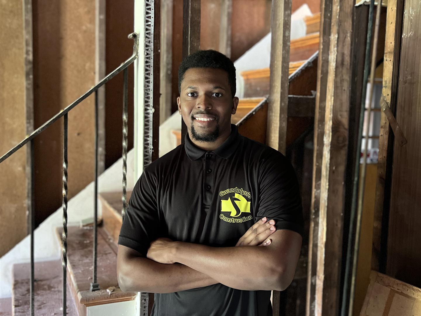 Imani Gray standing in front of a staircase in a home that is being remodeled